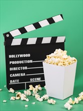 Delicious popcorn box with movie clapperboard