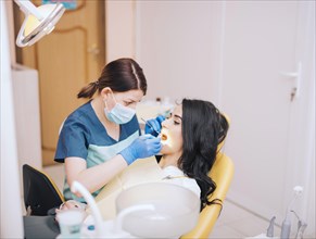 Dentist examining patients teeth clinic
