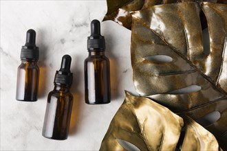 Different bottles skincare oils marble background