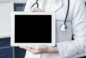 Doctor with stethoscope tablet