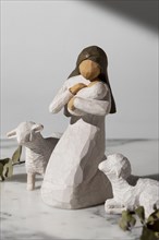 Epiphany day female figurine with newborn sheep