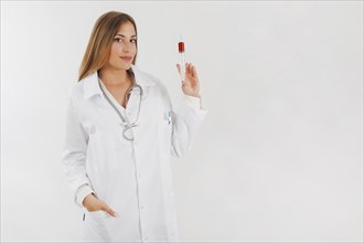 Female doctor showing tube filled with blood