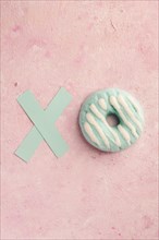 Flat lay glazed doughnut with letter x