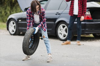 Front view woman holding tire