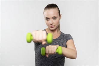 Front view woman with physiotherapy weights
