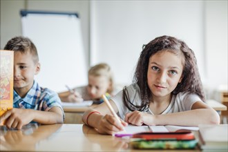 Girl sitting table writing