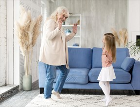 Grandma with girl home playing