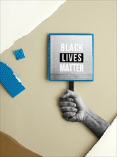 Hand holding black lives matter sign