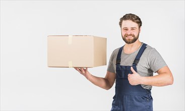 Happy delivery man with box showing thumb up