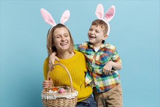Happy mother son with basket painted eggs