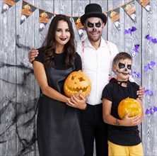Happy parents with son posing halloween