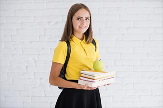 Happy teen girl with books