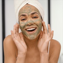 Happy woman having homemade mask her face