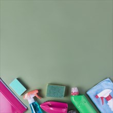 High angle view cleaning supplies green background
