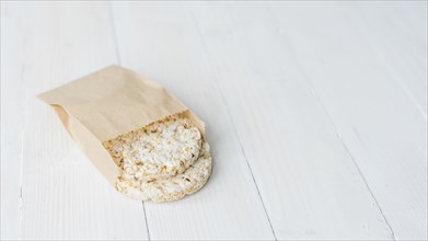 Homemade crispy puffed rice brown paper bag white wooden desk