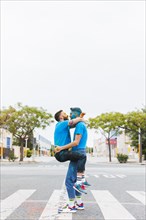 Homosexual couple hugging holi festival