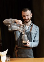 Male preparing coffee customers