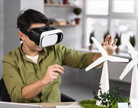 Man working eco friendly wind power project with virtual reality headset