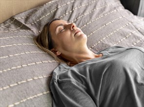 Medium shot woman laying bed