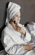 Medium shot woman massaging face
