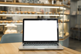 Open laptop with blank white screen display table coffee shop
