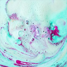 Pink turquoise blue bath bomb dissolving water