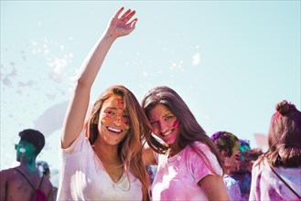 Portrait smiling young women enjoying holi festival