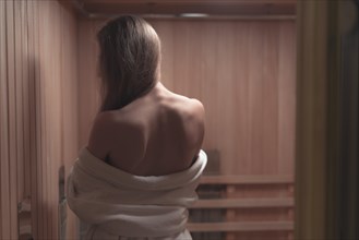 Rear view backless sexy young woman sauna