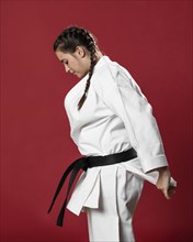 Sideways karate woman traditional white kimono red background