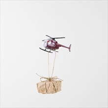 Small gift box hanging flying helicopter
