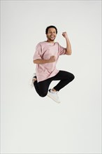 Smiley young man jumping