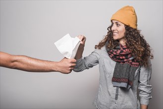 Smiling sick woman taking tissue paper from man s hand