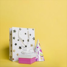 Star shape shopping bag paper hat gift box yellow background