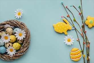 Top view easter eggs basket with chamomile flowers