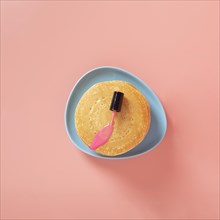 Top view pink nail polish pancakes with plain background