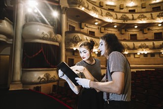Two mime artist reading manuscript stage
