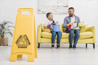 Wet floor sign with defocused father son