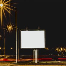 White billboard with traffic lights night