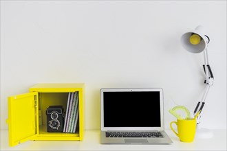 White stylish workplace white yellow colors with laptop yellow box