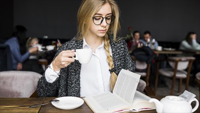 Woman drinking reading book