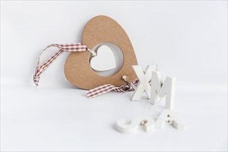 Wooden heart shape ornament with xmas text isolated white background