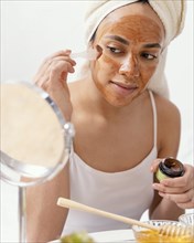 Young woman applying natural face mask 3
