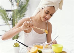 Young woman making natural face mask home 2