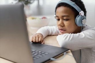 Boy listening music using laptop