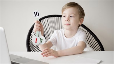 Child holding numbers mathematics online course