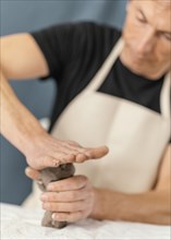 Close up blurry man holding clay 2