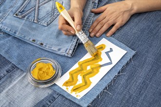Close up hand painting jeans