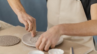 Close up hands doing pottery