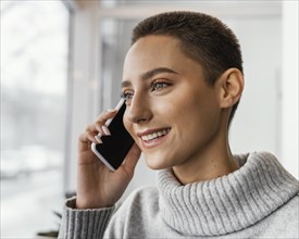 Close up happy woman talking phone