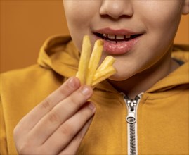 Close up kid eating fries
